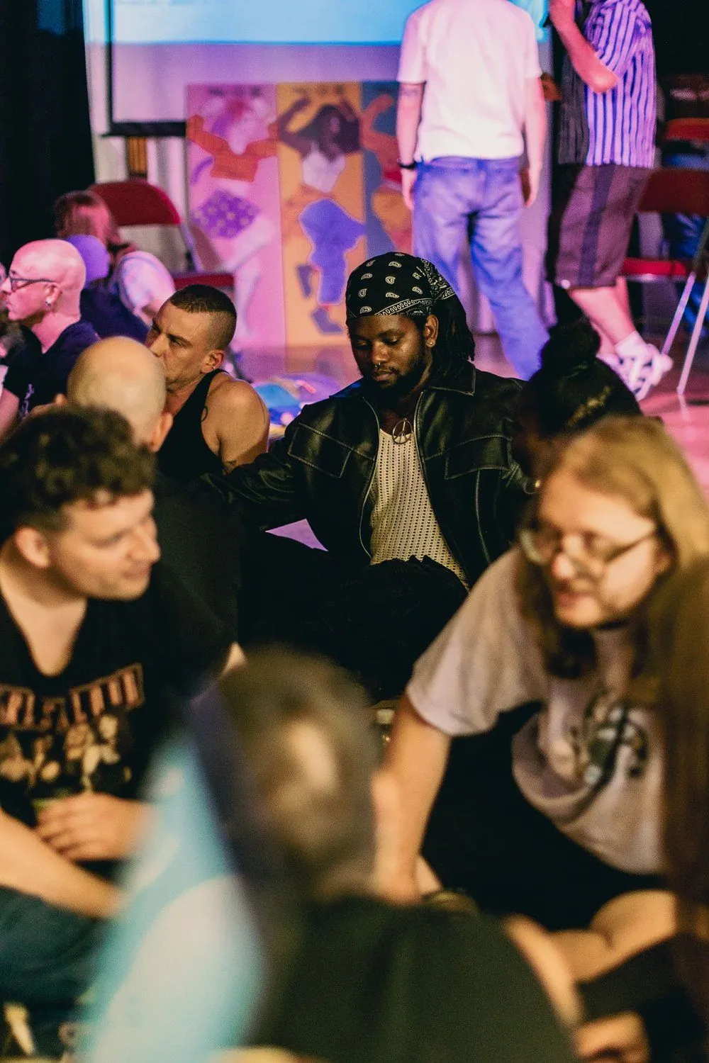 Participants gathering in small groups during an evening workshop