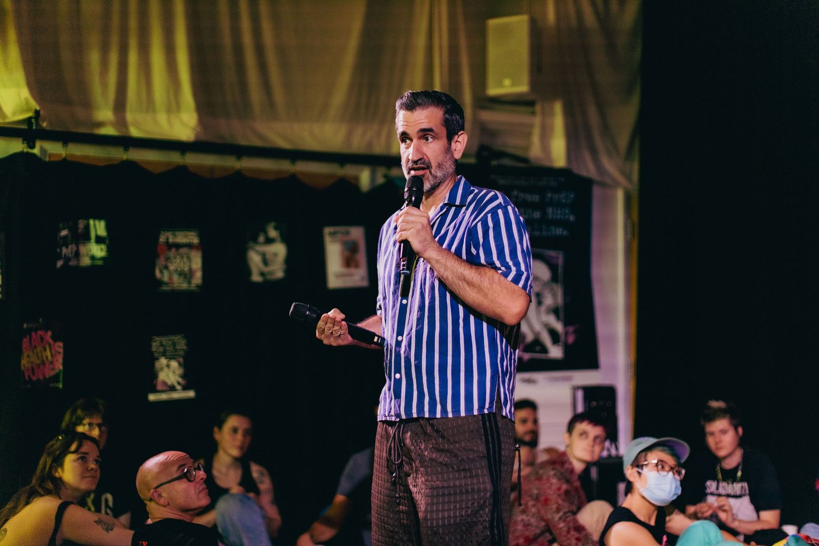 Angel Perez facilitating a PolyStation workshop, speaking into a microphone