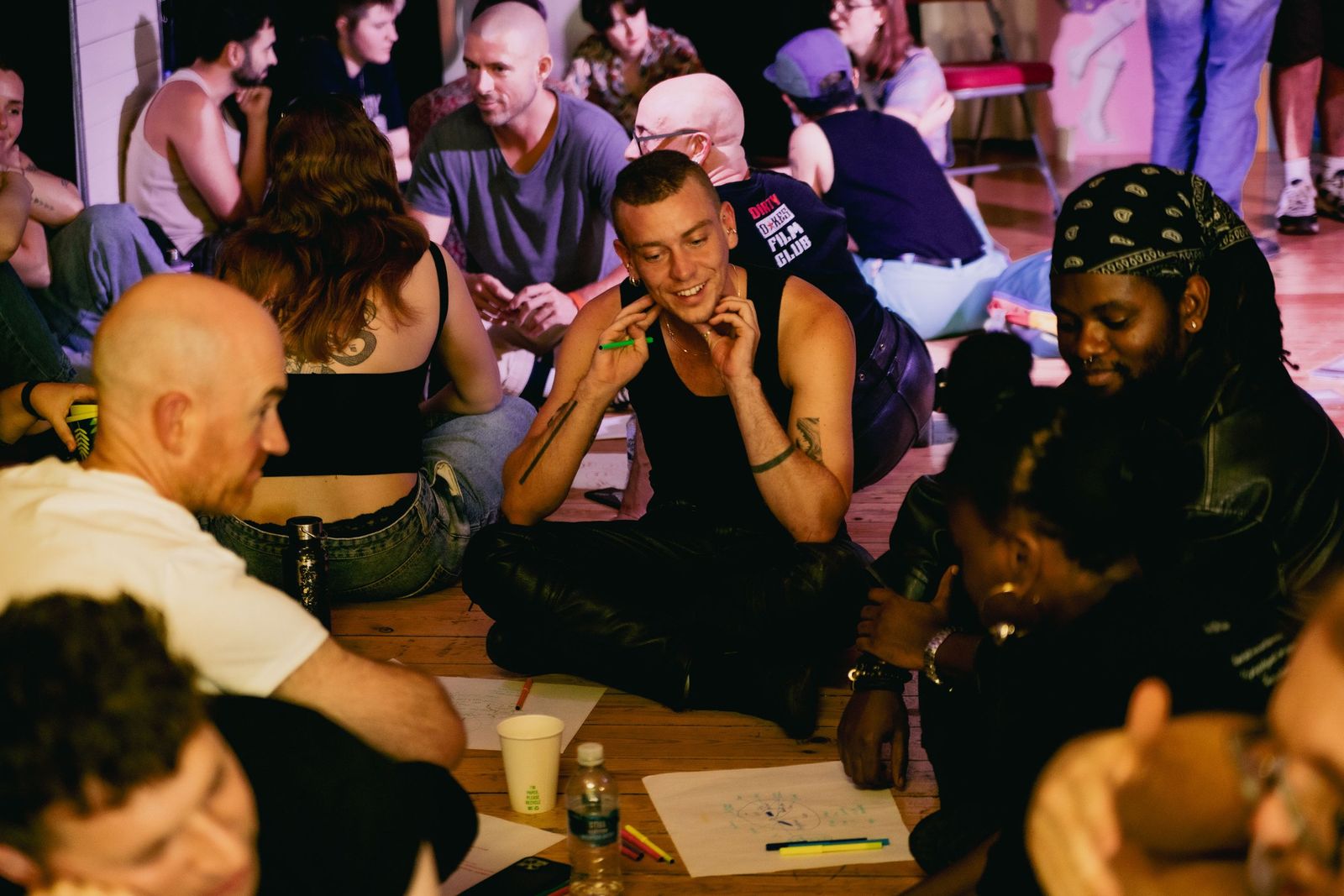 Participants smiling and chatting in small groups during the workshop